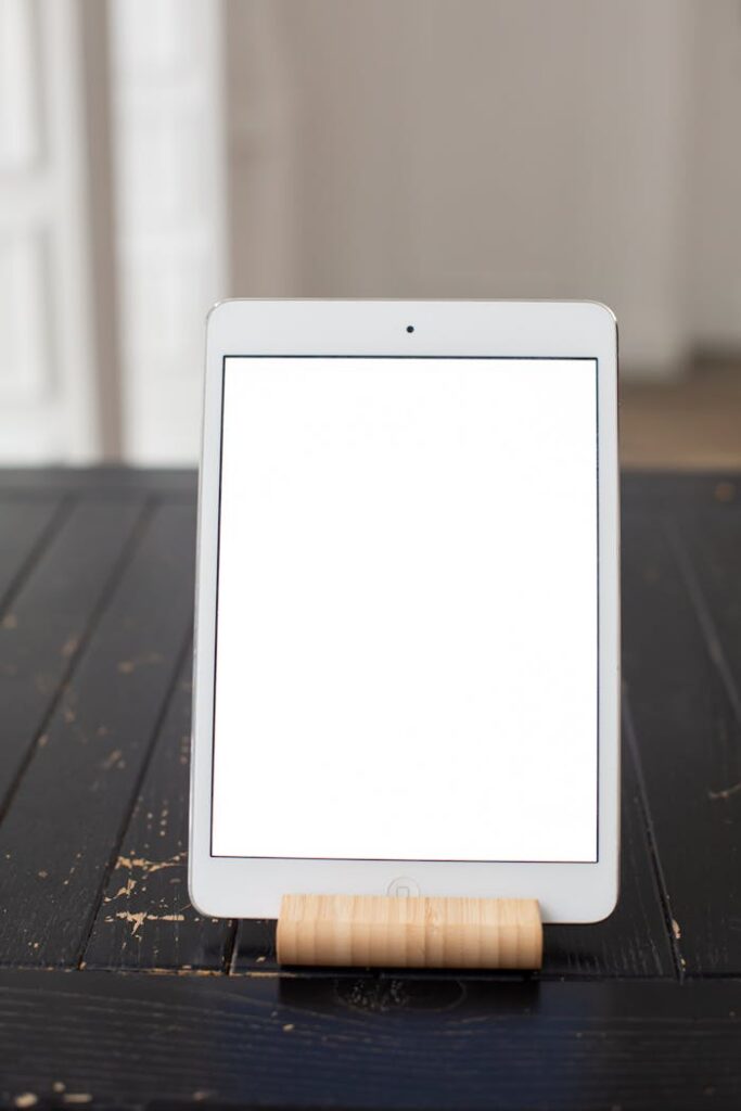Vertical tablet mockup on a rustic wooden table ideal for app and website design presentations.